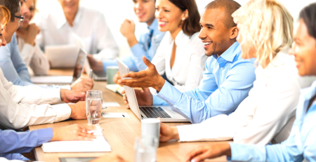 A group of people meeting around a boardroom table