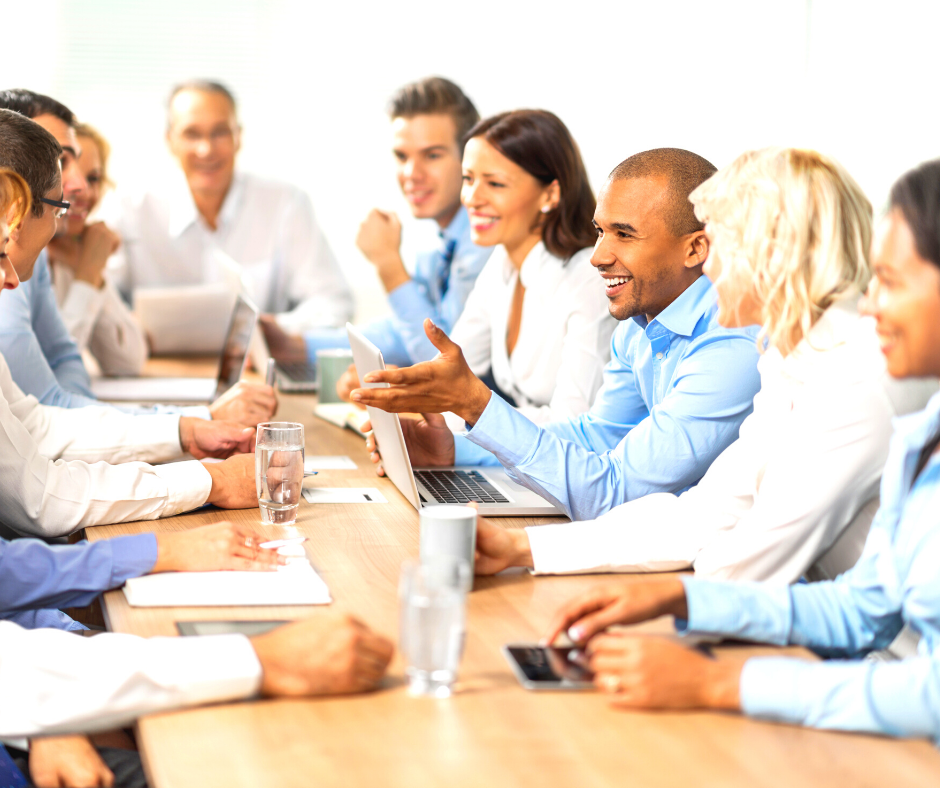 A group of people meeting around a boardroom table