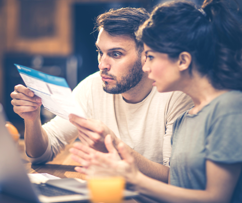 Shocked couple looking at a bill