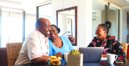 Elderly couple and younger woman laughing