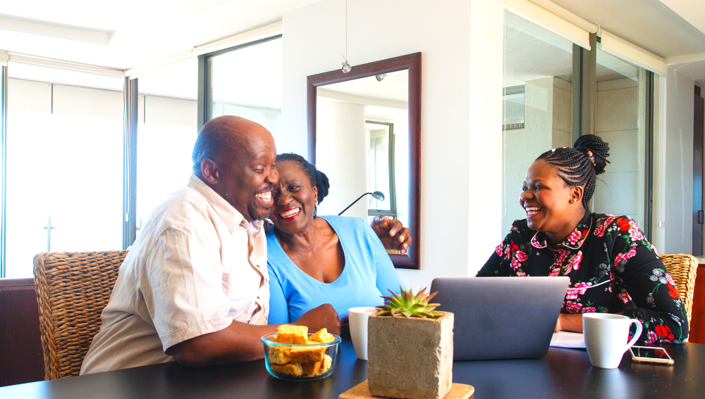 Elderly couple and younger woman laughing