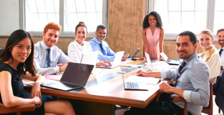 Smiling people around a boardroom table