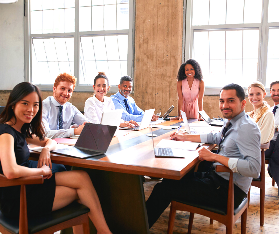 Smiling people around a boardroom table