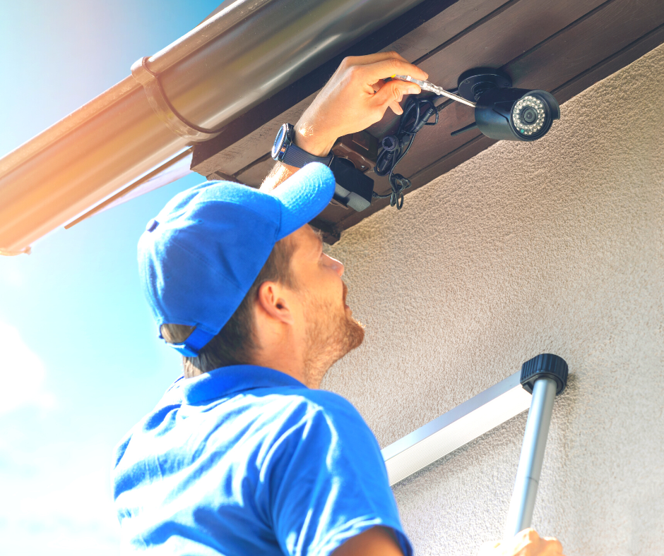 Man installing a security camera
