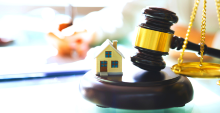 Scales, gavel and model of a house