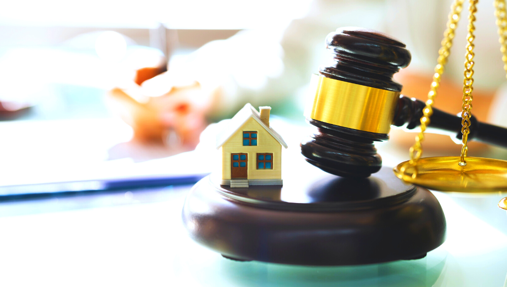 Scales, gavel and model of a house