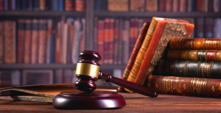 Antique books in a library and a gavel on a table