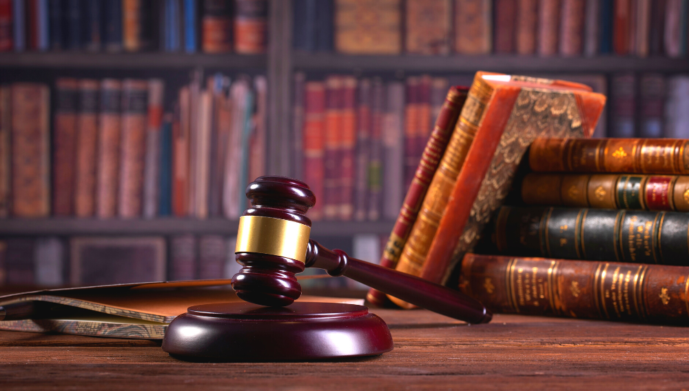 Antique books in a library and a gavel on a table