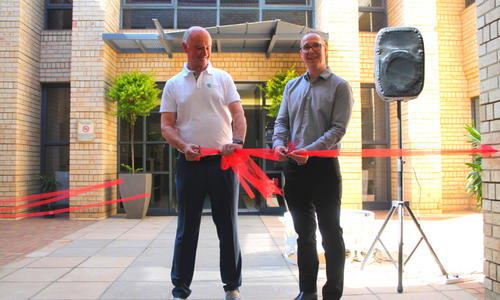Justin Mason and Johnny Wates cutting the ribbon in front of our new offices