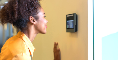A young woman's face being scanned by a device at an entrance