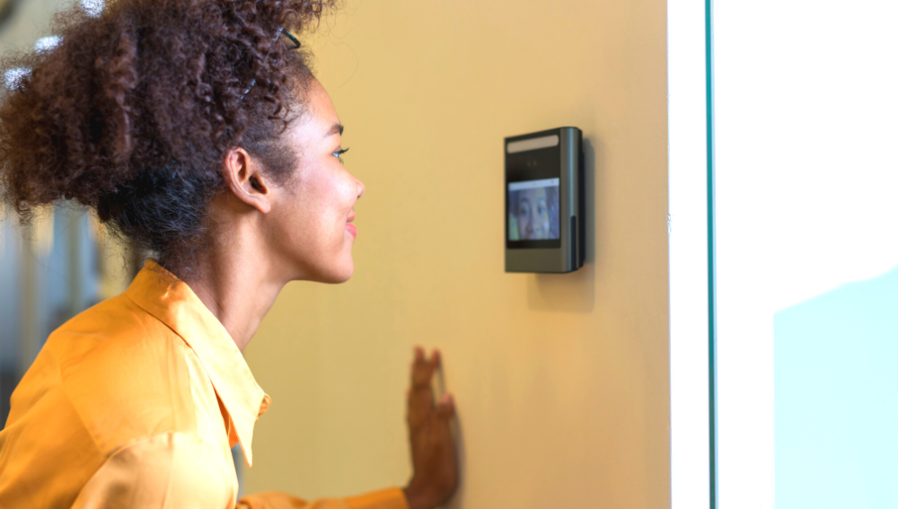 A young woman's face being scanned by a device at an entrance