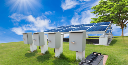 Solar panels and battery energy storage units in a sunny field