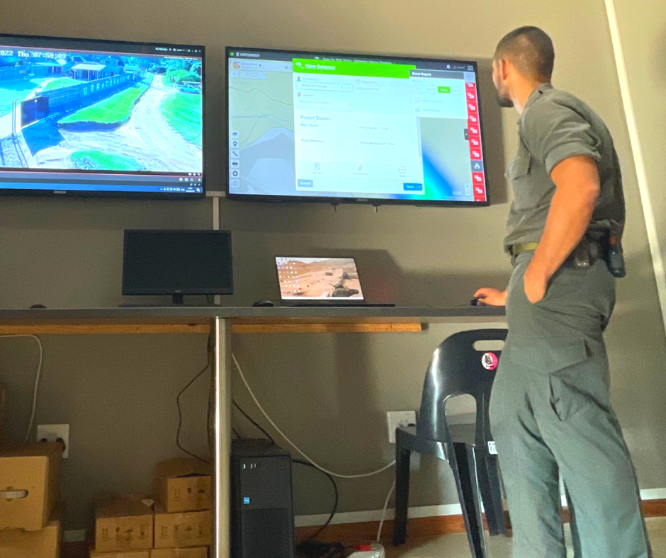 Care for Wild staff member in front of two display screens