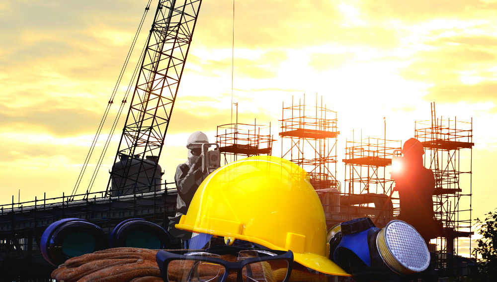 A hard hat and safety equipment in front of construction scaffolding