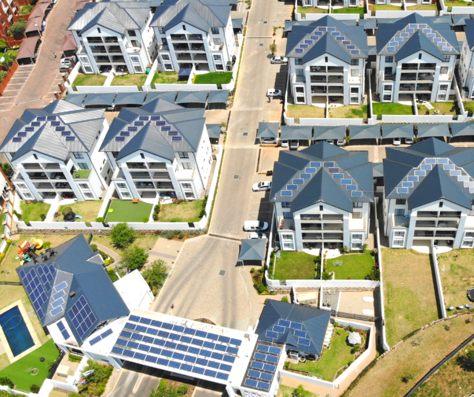 A wide angel photo of roof mounted solar panels at a community scheme from above