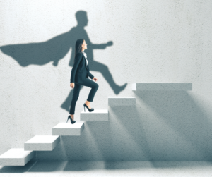 Photo of a woman climbing steps, with her shadow taking the form of a superhero with a cape.
